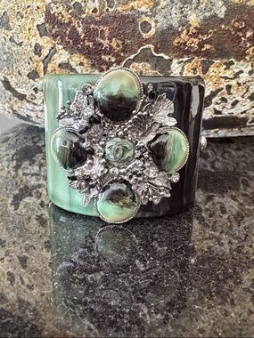 CHANEL Black and Green Resin Cuff Bracelet with Floral CC Medallion